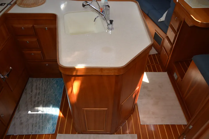 Slide: The Image of Interior of 2002 Sabre 402 yacht with wooden cabinetry and compact kitchen area. - 72