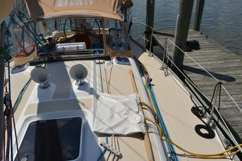 Slide: The Image of Deck view of a 2002 Sabre 402 sailboat docked at a marina. - 43