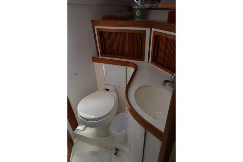 Slide: The Image of Compact bathroom in a 2002 Sabre 402 yacht with wooden cabinetry and modern fixtures. - 119