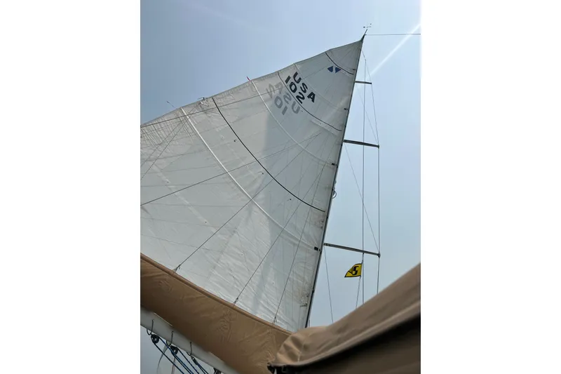 Slide: The Image of Sailboat mast and sail of 2002 Sabre 402 under clear sky. - 24