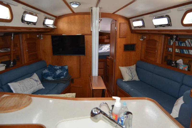 Slide: The Image of Interior of a 2002 Sabre 402 sailboat with cozy seating and wooden finishes. - 76