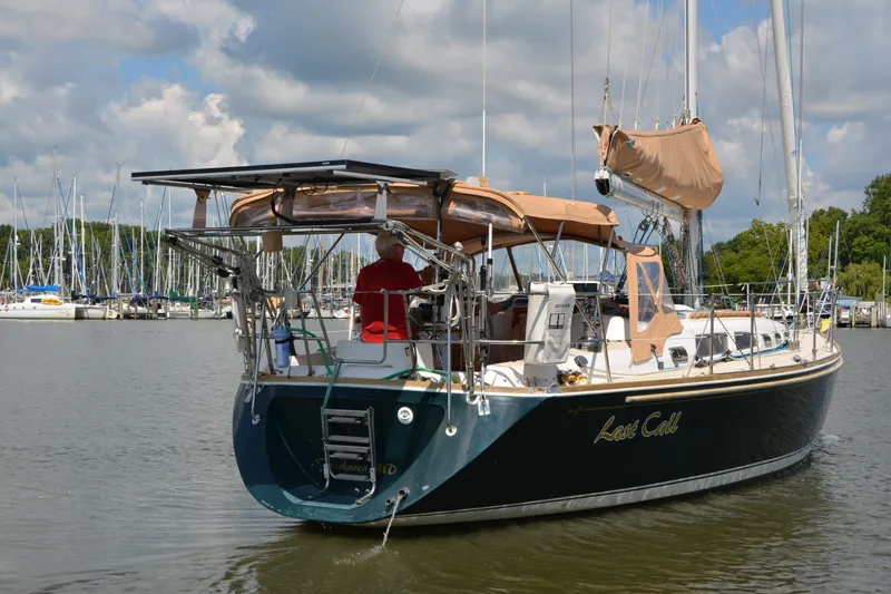 Slide: The Image of Sailing yacht "Last Call," Sabre 402, 2002 model, docked in a marina under cloudy skies. - 7