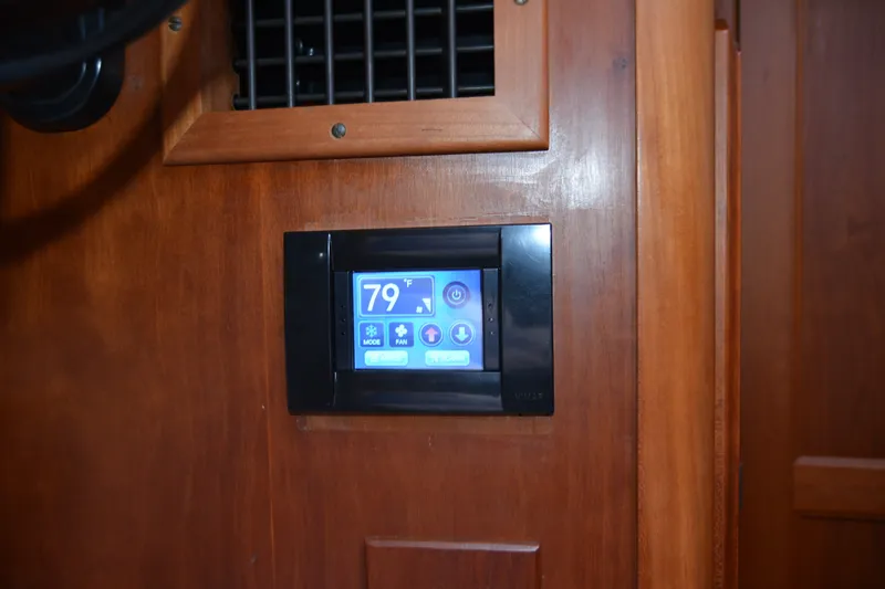 Slide: The Image of Touchscreen thermostat on 2002 Sabre 402 yacht, displaying 79°F, mounted on wooden panel. - 92
