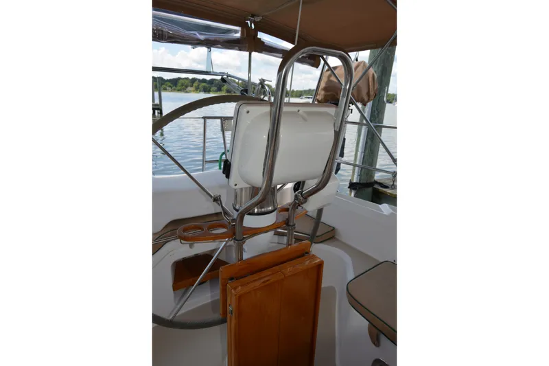 Slide: The Image of Cockpit of 2002 Sabre 402 sailboat with steering wheel and seating. - 68