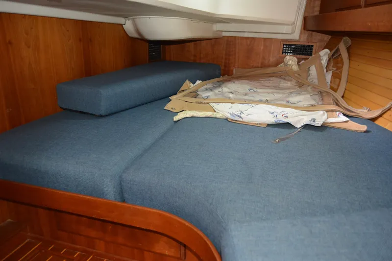 Slide: The Image of Interior cabin of 2002 Sabre 402 yacht with blue cushions and wooden paneling. - 130