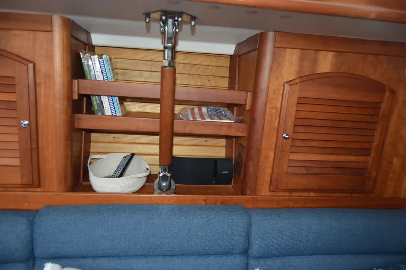 Slide: The Image of Wooden interior of a 2002 Sabre 402 yacht with books and storage shelves. - 102
