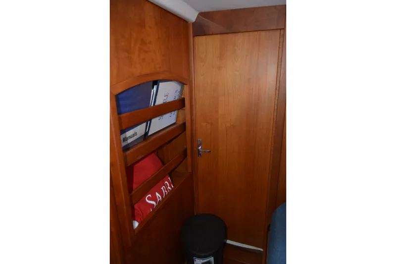 Slide: The Image of Interior of 2002 Sabre 402 sailboat with wooden cabinetry and storage shelves. - 131