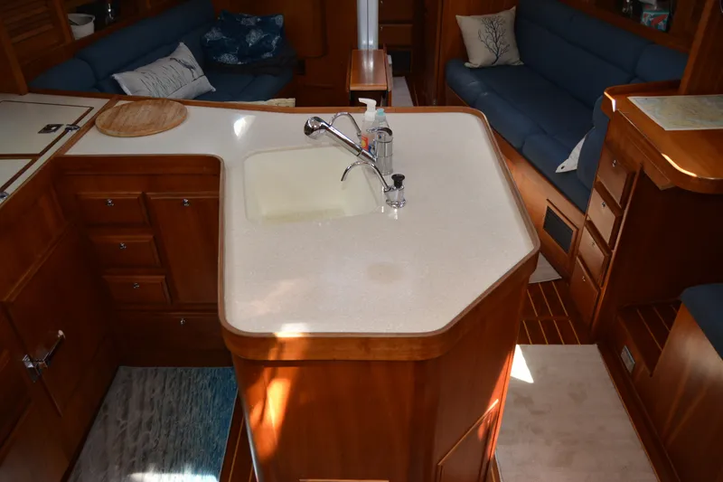Slide: The Image of Luxurious 2002 Sabre 402 yacht interior with elegant wooden cabinetry and modern kitchen amenities. - 71