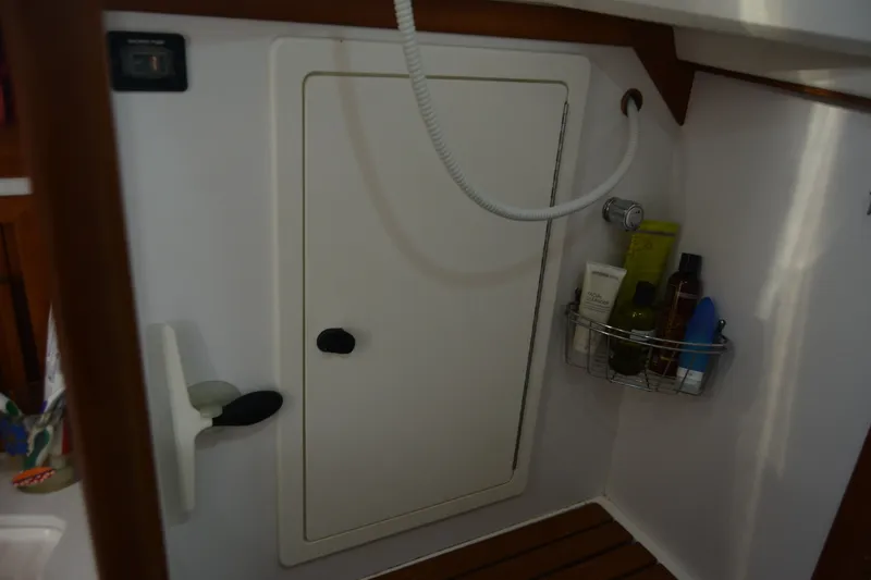 Slide: The Image of Interior of 2002 Sabre 402 yacht bathroom with shower and toiletries. - 121