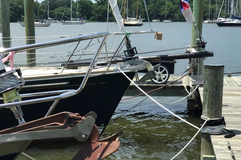 Slide: The Image of Sailboat docked at marina, Sabre 402 model, 2002, with scenic water and trees in background. - 28