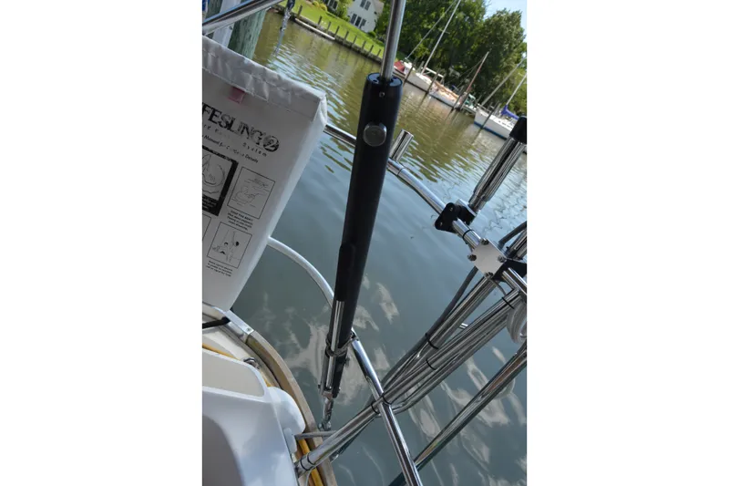 Slide: The Image of Boat railing and equipment on a 2002 Sabre 402 yacht by the water. - 66