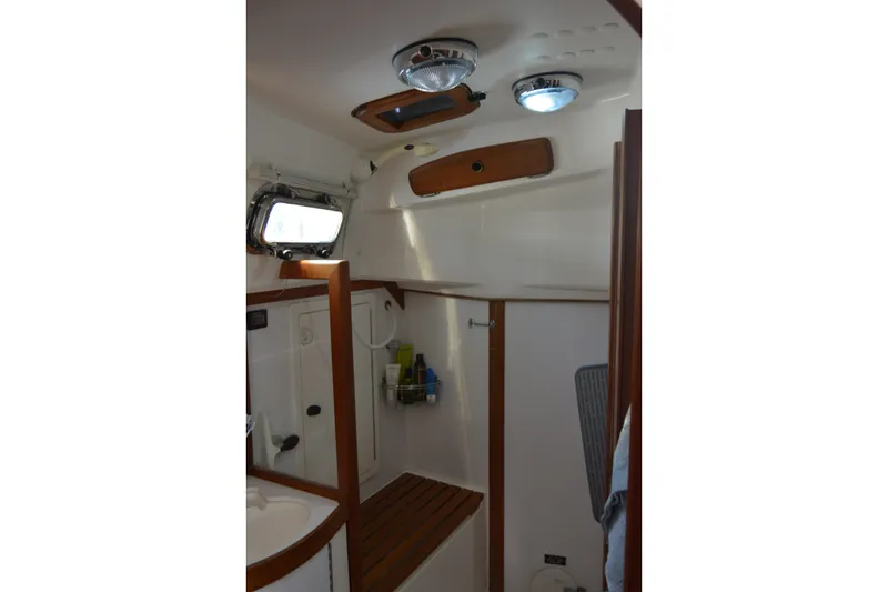 Slide: The Image of Interior of 2002 Sabre 402 sailboat bathroom with wooden accents and modern fixtures. - 115