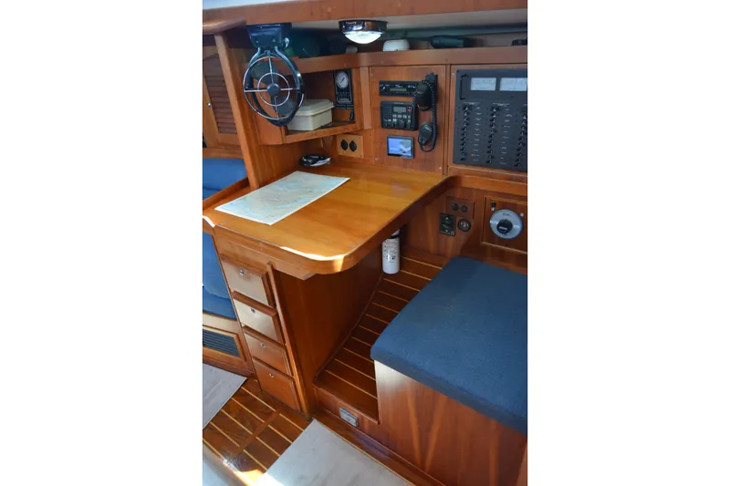 Slide: The Image of Navigation station in 2002 Sabre 402 yacht with wooden cabinetry and control panels. - 109