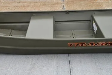 The Image of 2026 Tracker Grizzly 12 Jon boat, olive green, side view on concrete surface. - 0