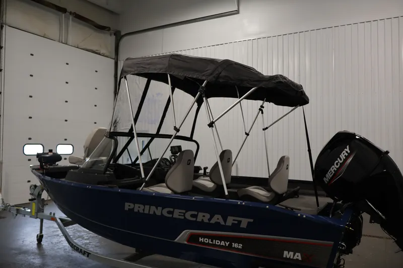Slide: The Image of 2025 Princecraft Holiday 162 WS MAX boat with canopy in a garage setting. - 39