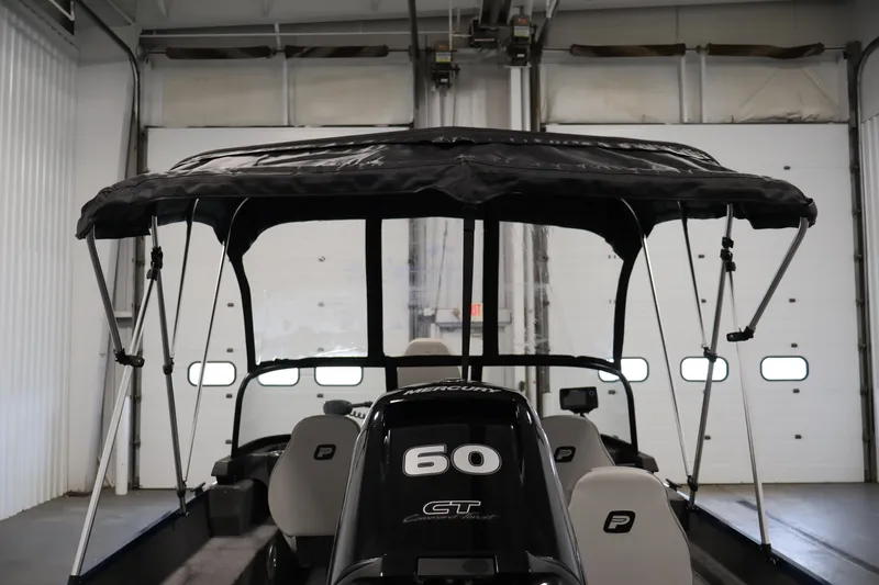 Slide: The Image of 2025 Princecraft Holiday 162 WS MAX boat with canopy in a garage setting. - 40