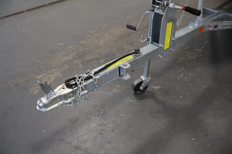 Slide: The Image of Trailer hitch of 2025 Princecraft Holiday 162 WS MAX boat, featuring safety chains and wheel. - 34