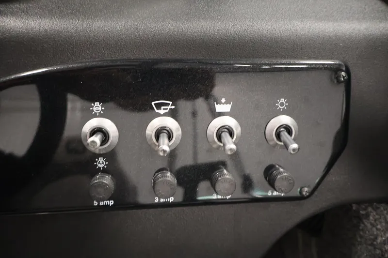 Slide: The Image of Control panel of 2025 Princecraft Holiday 162 WS MAX boat with toggle switches. - 24