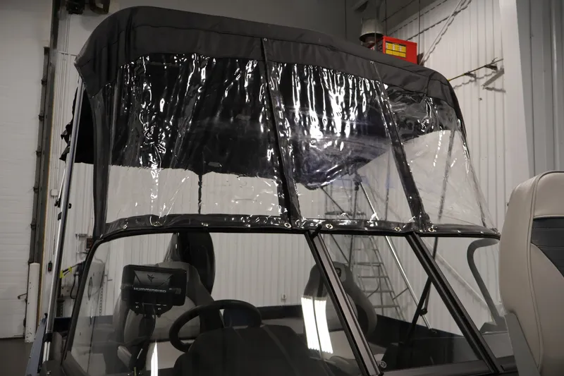 Slide: The Image of 2025 Princecraft Holiday 162 WS MAX boat with protective canopy in a garage setting. - 38