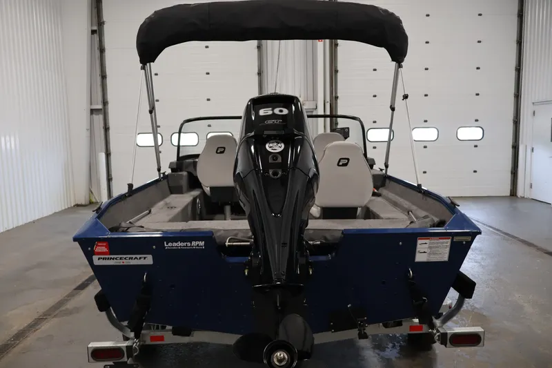 Slide: The Image of 2025 Princecraft Holiday 162 WS MAX boat with 60 HP engine in a garage setting. - 6