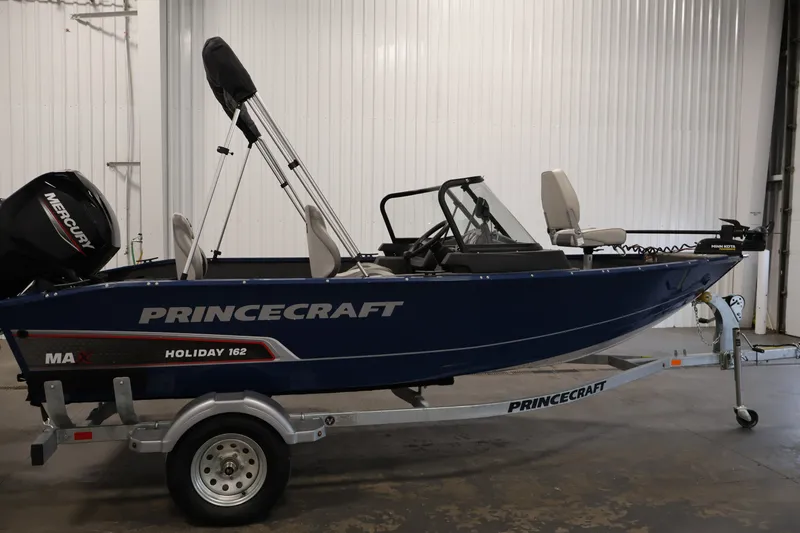 Slide: The Image of 2025 Princecraft Holiday 162 WS MAX boat on trailer in indoor setting. - 4