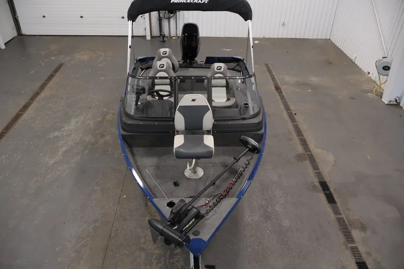 Slide: The Image of 2025 Princecraft Holiday 162 WS MAX boat in a garage, featuring modern seating and controls. - 9
