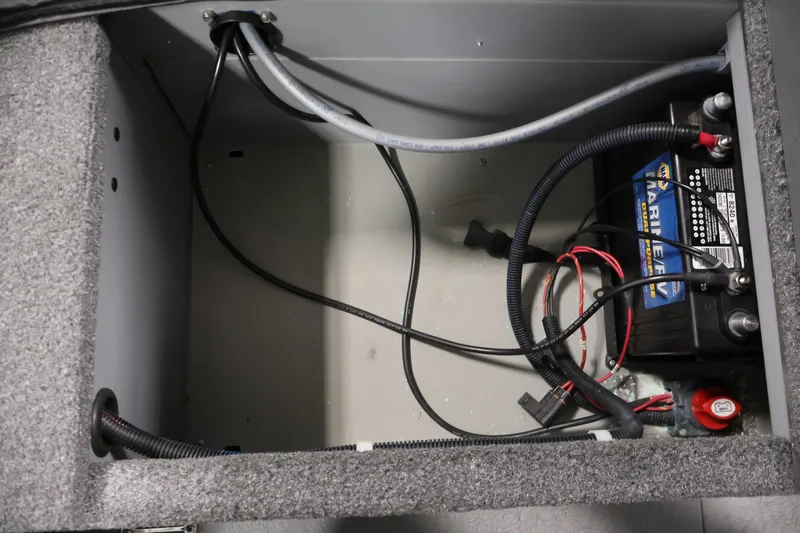 Slide: The Image of Battery compartment of 2025 Princecraft Holiday 162 WS MAX boat, featuring marine battery and wiring. - 31