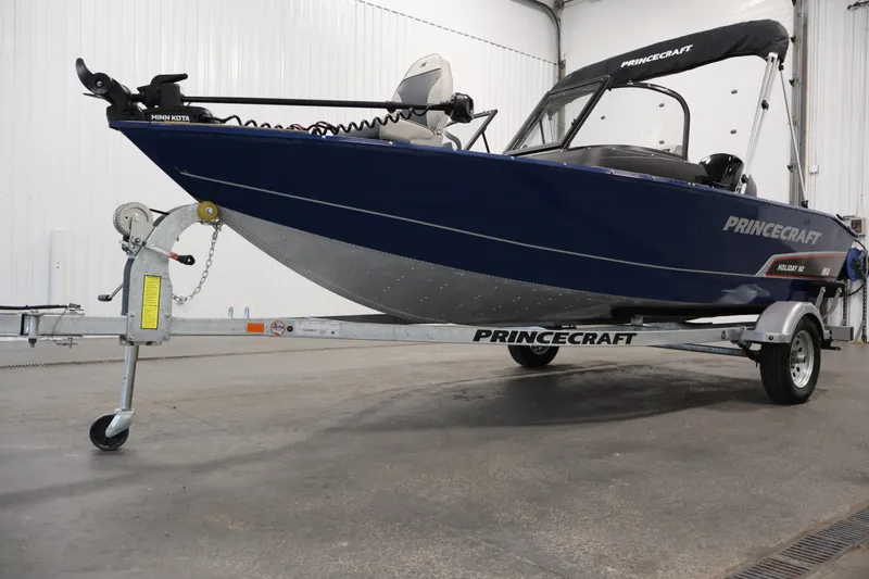 Slide: The Image of 2025 Princecraft Holiday 162 WS MAX boat on trailer in indoor setting. - 35