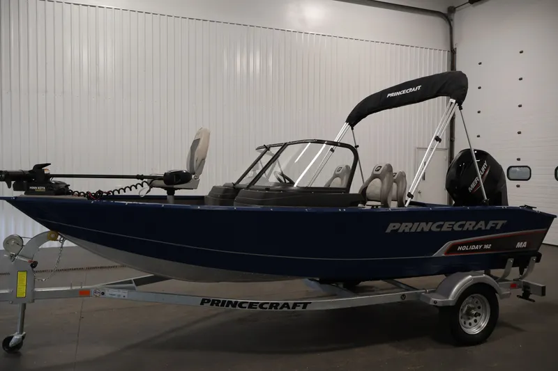 Slide: The Image of 2025 Princecraft Holiday 162 WS MAX boat on trailer in indoor setting. - 8