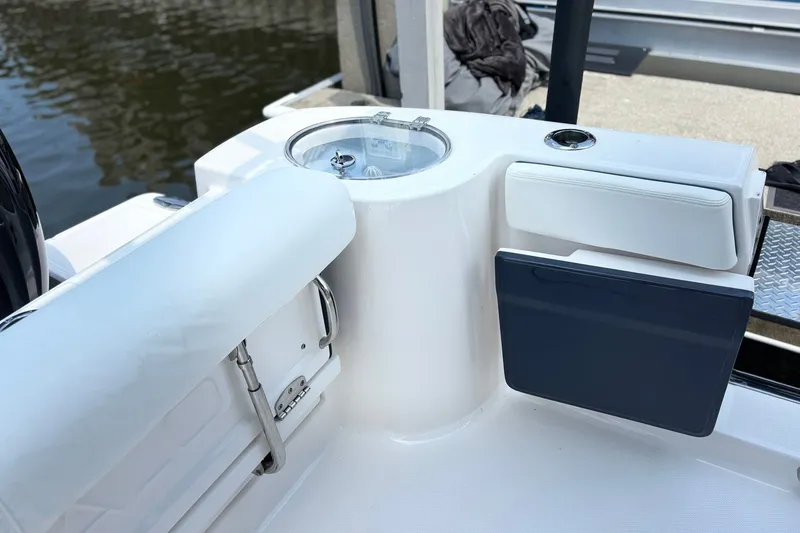 Slide: The Image of 2023 Robalo R272 Center Console boat interior with seating and storage compartments. - 21