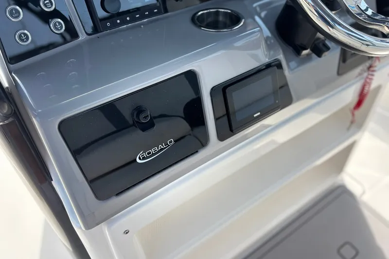 Slide: The Image of 2023 Robalo R272 Center Console dashboard with steering wheel and control panel. - 28