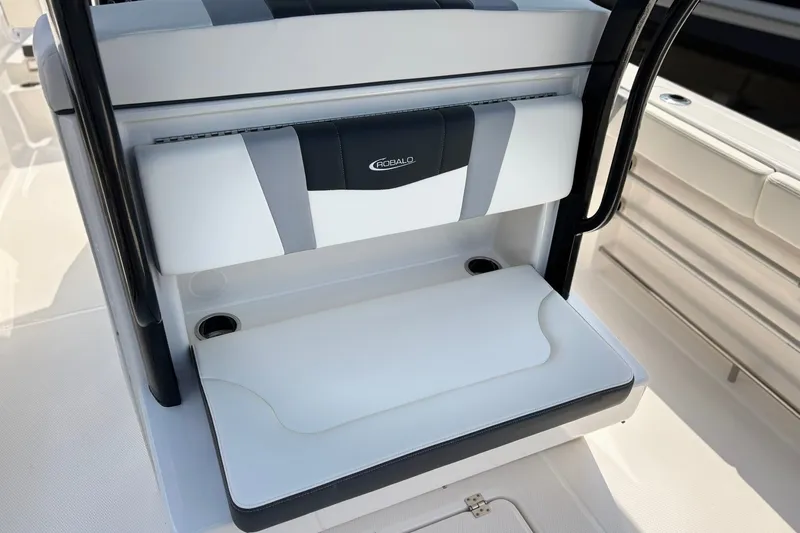 Slide: The Image of 2023 Robalo R272 Center Console seating area with cup holders and sleek design. - 17