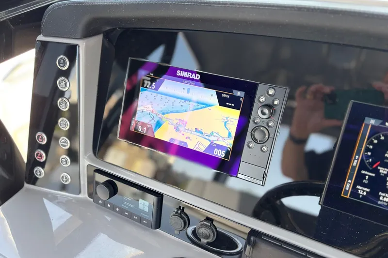 Slide: The Image of 2023 Robalo R272 Center Console dashboard with Simrad navigation display. - 32