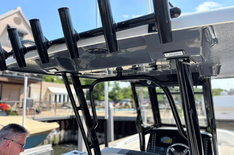 Slide: The Image of 2023 Robalo R272 Center Console boat with rod holders and console details. - 42