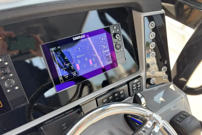 Slide: The Image of 2023 Robalo R272 Center Console dashboard with Simrad display and controls. - 33