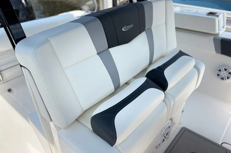 Slide: The Image of 2023 Robalo R272 Center Console boat seat with white and gray upholstery. - 24
