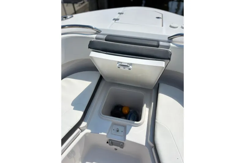 Slide: The Image of 2023 Robalo R272 Center Console boat storage compartment with open lid. - 48