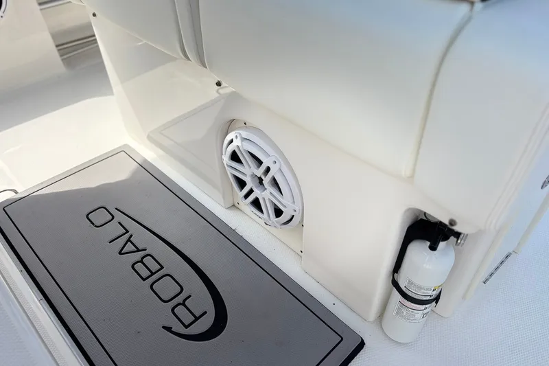 Slide: The Image of 2023 Robalo R272 Center Console interior with speaker and branded mat. - 26
