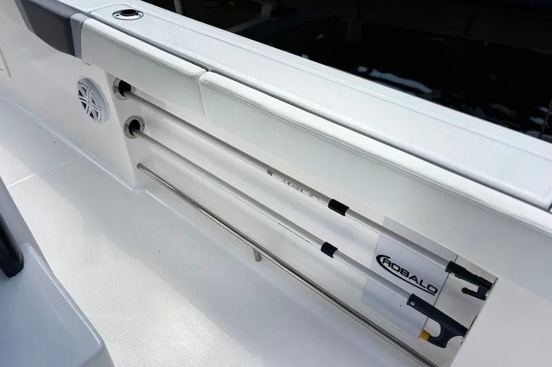 Slide: The Image of 2023 Robalo R272 Center Console boat interior with rod storage and speaker. - 23