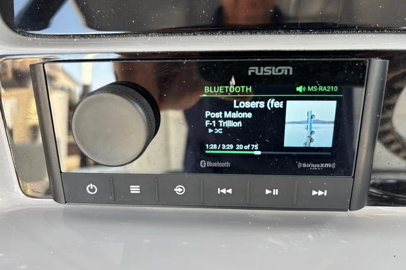 Slide: The Image of Fusion MS-RA210 stereo on 2023 Robalo R272 Center Console, playing Post Malone via Bluetooth. - 34