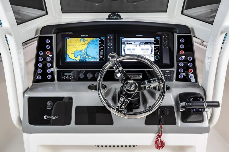 Slide: The Image of Manufacturer Provided Image: 2023 Robalo R272 Center Console boat dashboard with navigation screens and steering wheel. - 55