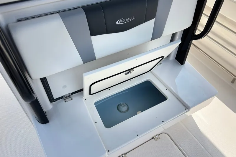 Slide: The Image of 2023 Robalo R272 Center Console boat seat with storage compartment open. - 18