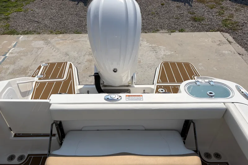 Slide: The Image of Edgewater 230CC 2022 boat stern with motor and seating area. - 25