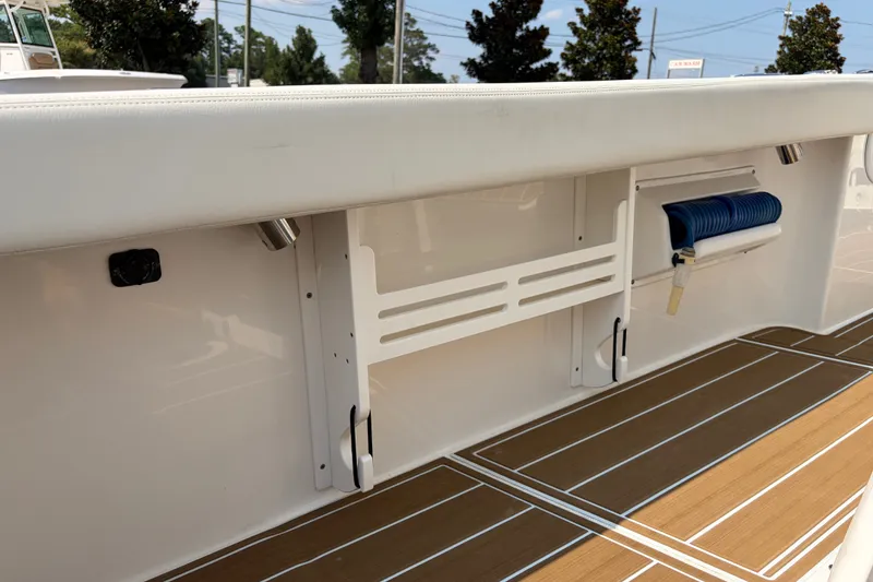 Slide: The Image of 2022 Edgewater 230CC boat interior with teak flooring and storage compartments. - 23