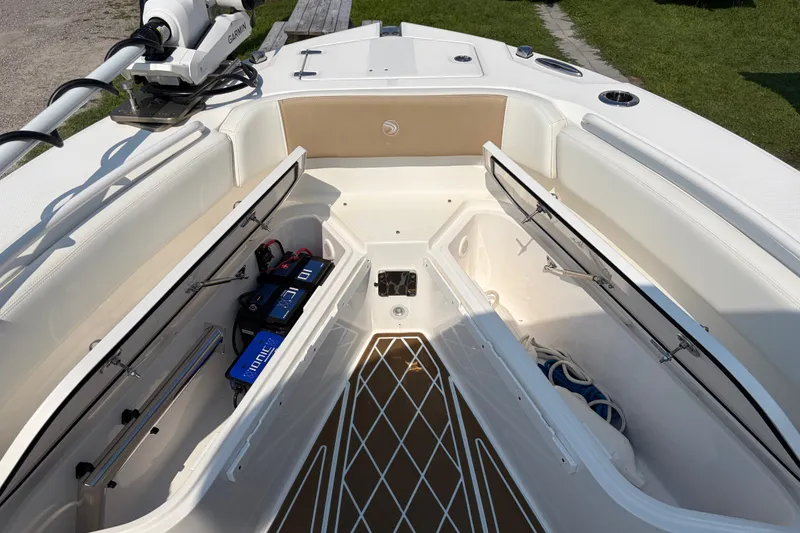 Slide: The Image of 2022 Edgewater 230CC boat interior with storage compartments and Garmin equipment. - 8