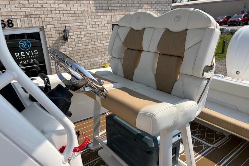 Slide: The Image of 2022 Edgewater 230CC boat interior with cushioned seating and steering wheel. - 17