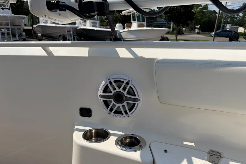 Slide: The Image of 2022 Edgewater 230CC boat interior with speaker and cup holders. - 10