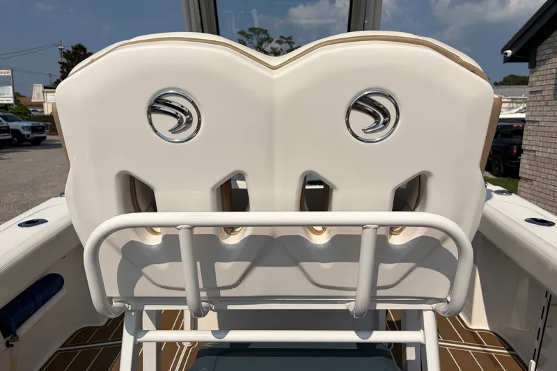 Slide: The Image of 2022 Edgewater 230CC boat seating with logo, outdoor setting. - 20
