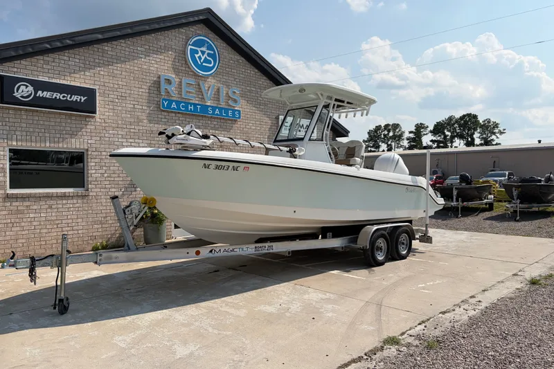 Slide: The Image of 2022 Edgewater 230CC boat on trailer at Revis Yacht Sales dealership. - 1