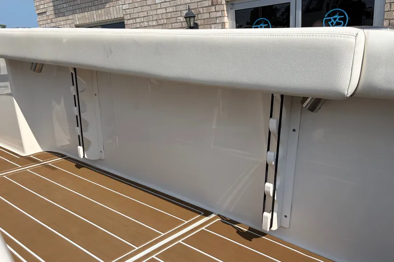 Slide: The Image of Edgewater 230CC 2022 boat interior with cushioned seating and teak-style flooring. - 24